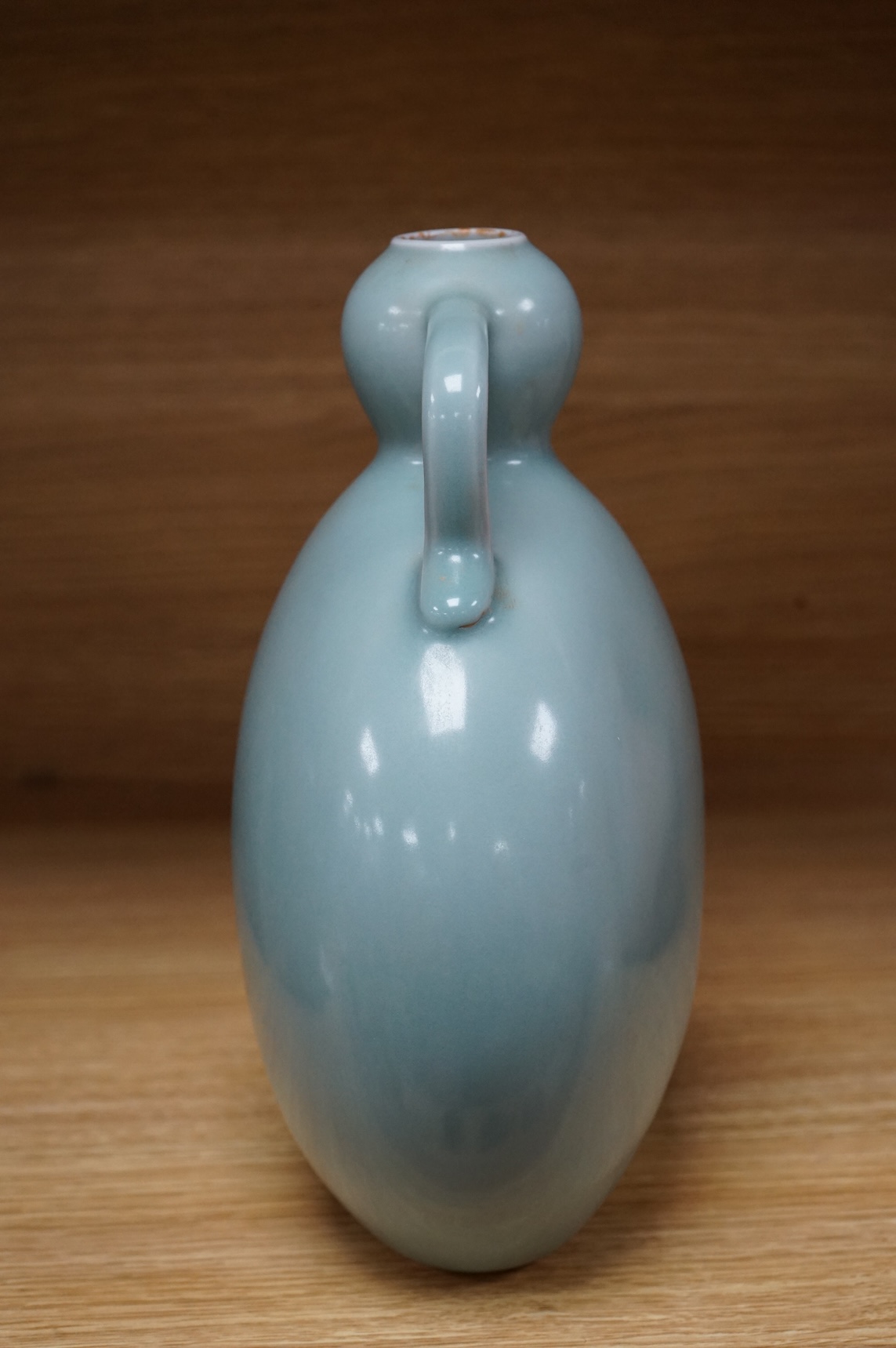 A Chinese celadon glazed two handled moon vase, 24cm high